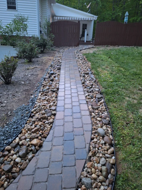 Custom stone pathway installation by Olmedo Home Services