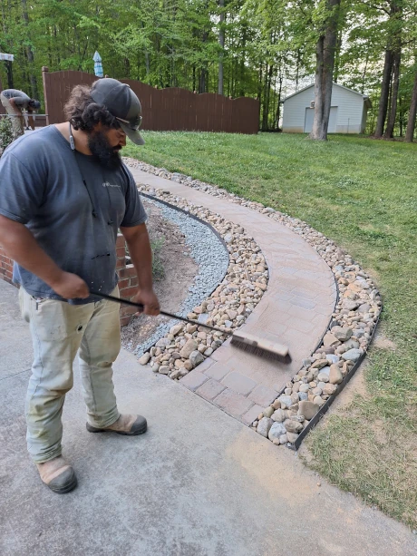 Worker Installing Stone Pathway